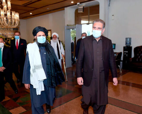 Pakistan's Foreign Minister Shah Mahmood Qureshi, right, and Mullah Abdul Ghani Baradar