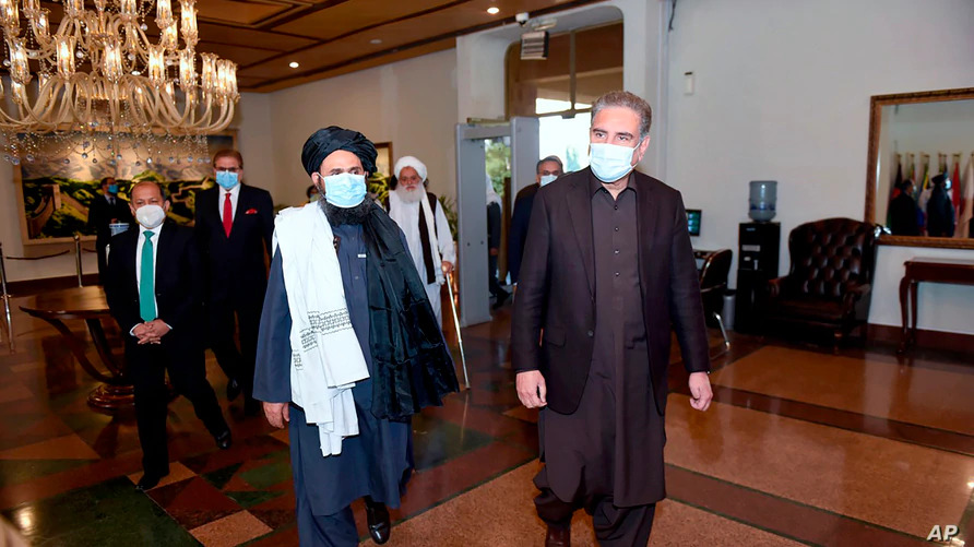 Pakistan's Foreign Minister Shah Mahmood Qureshi, right, and Mullah Abdul Ghani Baradar