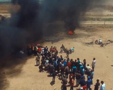 Demonstrators walking towards protest site by Gaza separation fence in 2018,