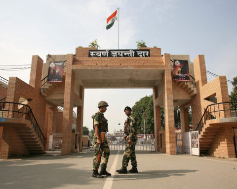 India's BSF soldiers patrol in front of the golden jubilee gate at the Wagah border