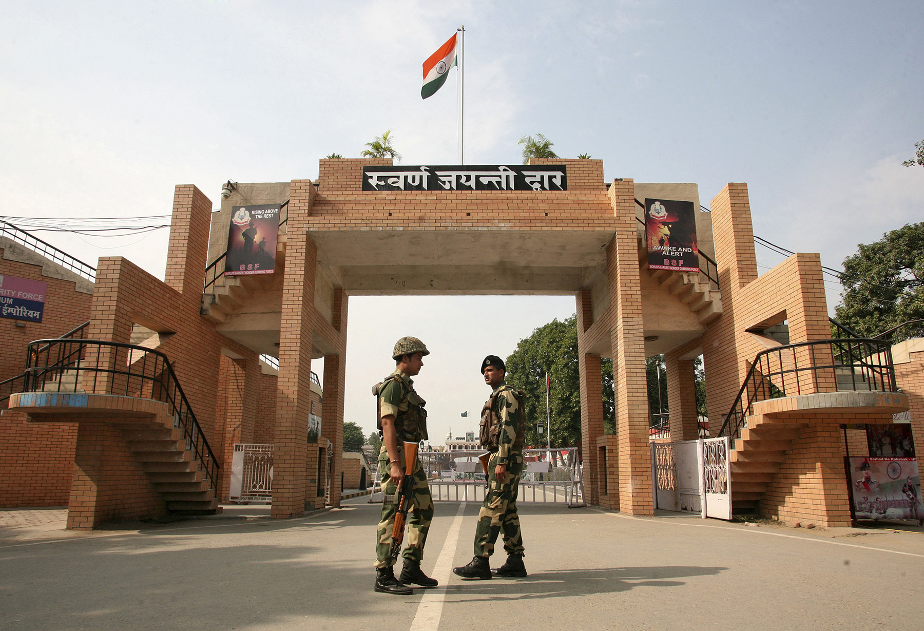 India's BSF soldiers patrol in front of the golden jubilee gate at the Wagah border