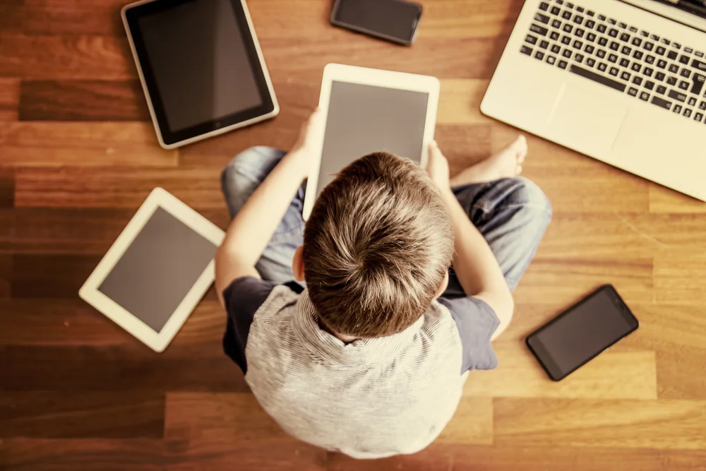 children surrounded by technology