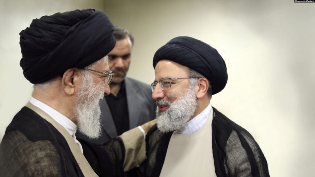 Iranian Supreme Leader Ayatollah Ali Khamenei (left) talks to Ebrahim Raisi