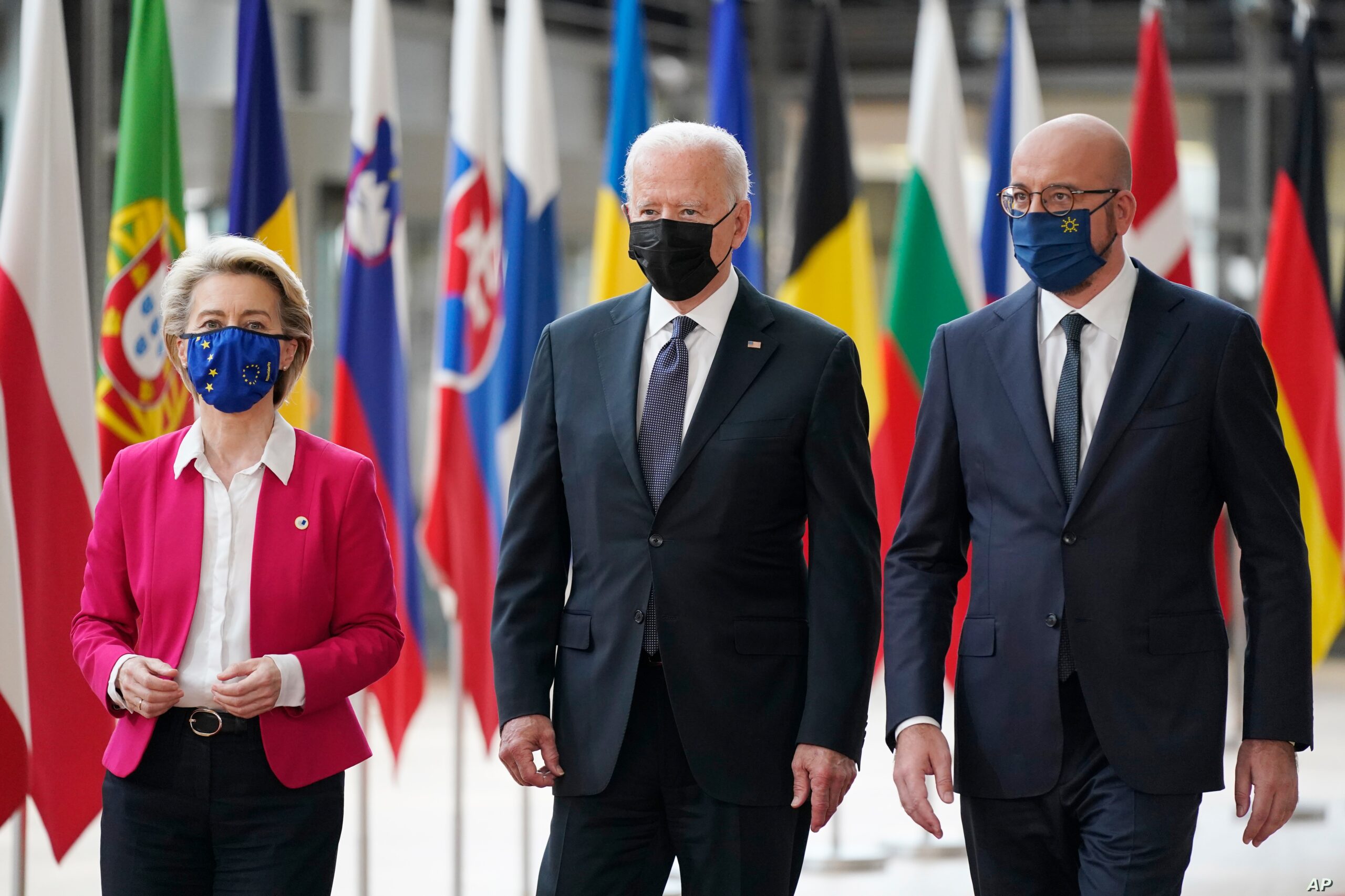 President Joe Biden, center, walks with European Council President Charles Michel, right, and European Commission President Ursula von der Leyen