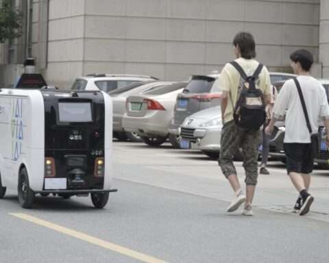 Robot in action delivering packages on a university campus in Wuhan, China