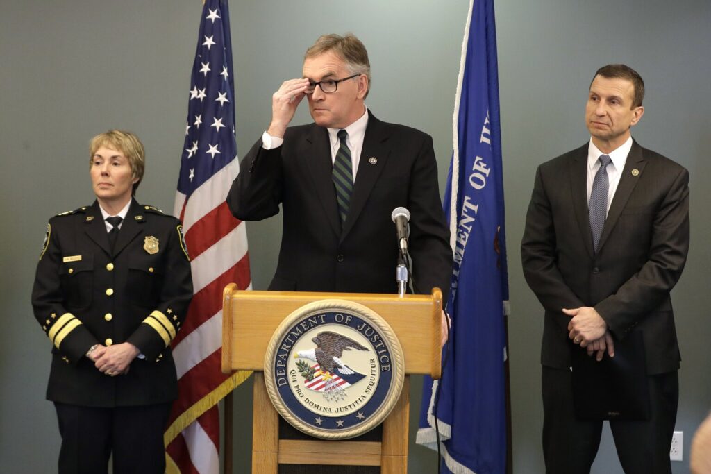 .S. Attorney Brian Moran, center, is flanked by Seattle Assistant Chief of Police Deanna Nollette