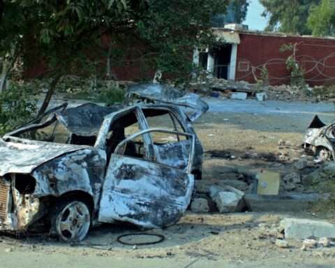 Cars, which were torched by an angry mob