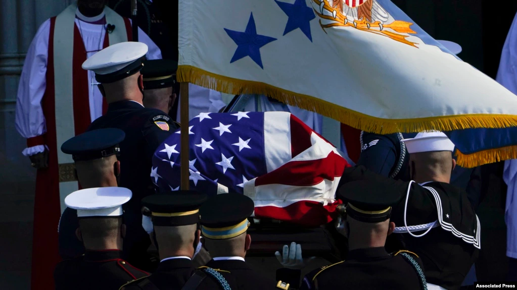 The flag-draped casket of former Secretary of State Colin Powell