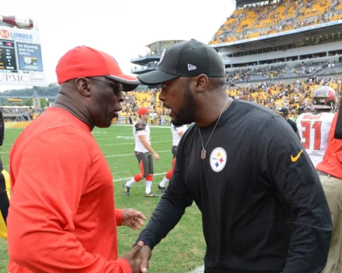 ovie Smith, left, and Pittsburgh Steelers head coach Mike Tomlin