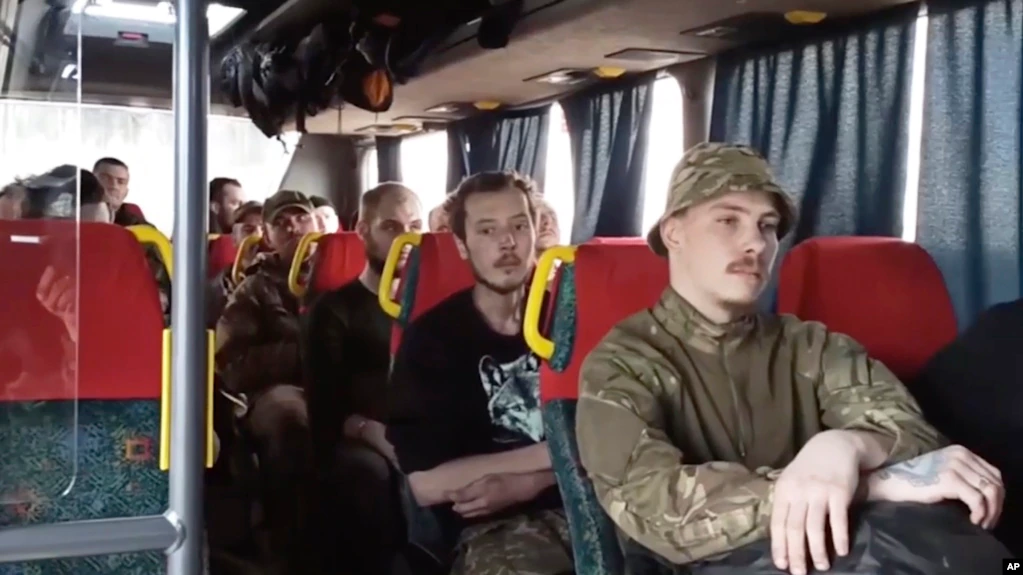 Ukrainian soldiers sit in a bus