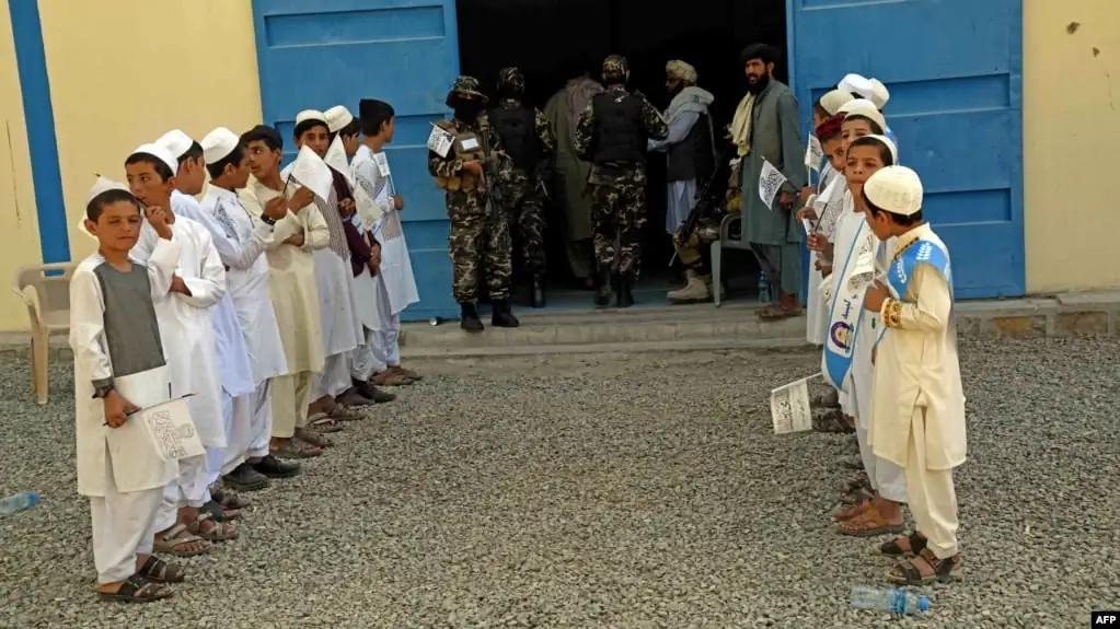 Afghan children hold flags
