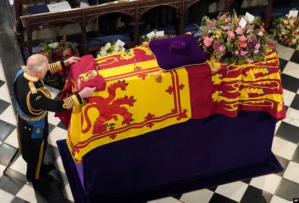 King Charles III places the Queen's