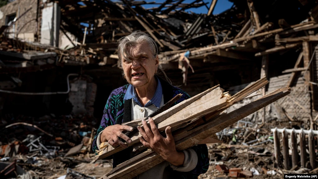 A woman collects wood