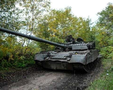 Ukrainian servicemen drive a T-80