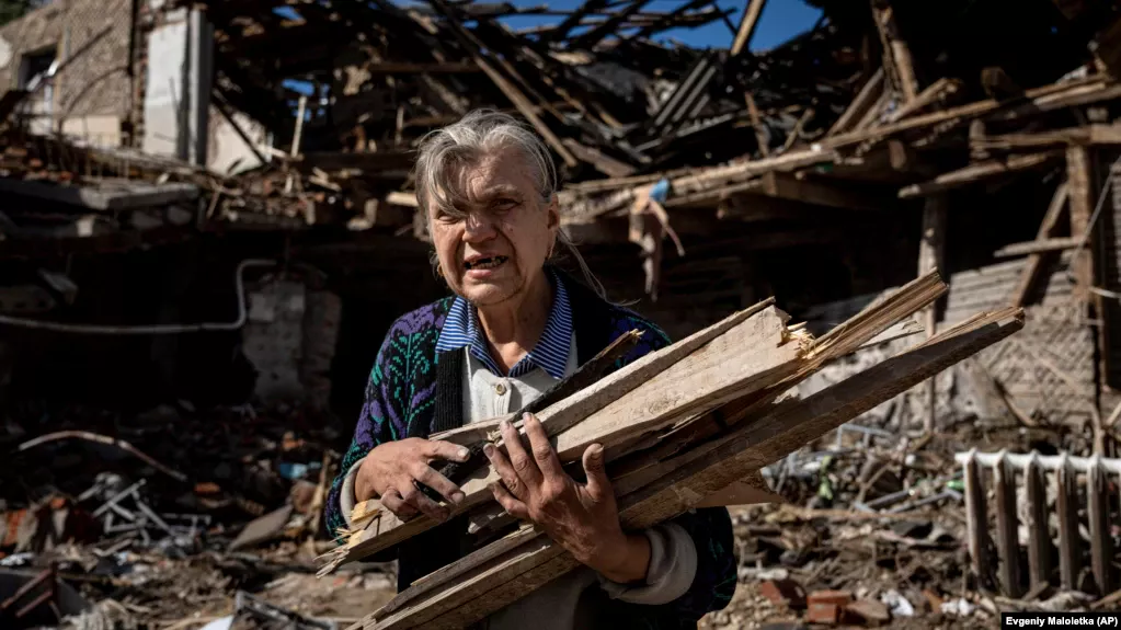 A woman collects wood