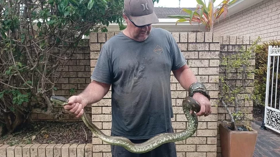 Ben Blake holding the offending python