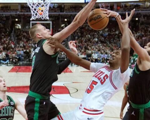 Boston Celtics' Derrick White, right, blocks the shot of Chicago Bulls' Julian Phillips